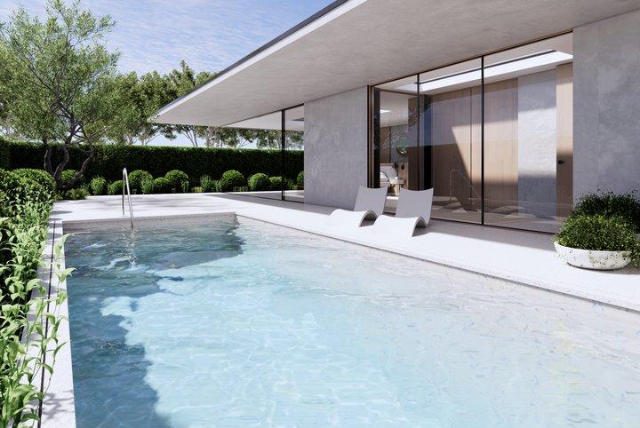Lap pool edged in pale stone, with sun loungers, clipped hedging and an olive tree beside a glass pavilion
